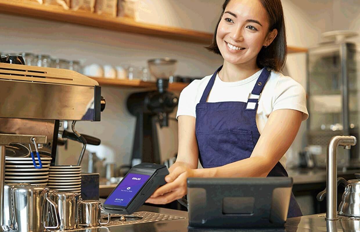 Cafe staff member accepting OOLIO payment